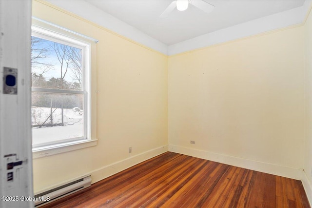 empty room with a ceiling fan, a baseboard radiator, baseboards, and wood finished floors