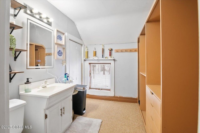 bathroom featuring vaulted ceiling, vanity, and toilet