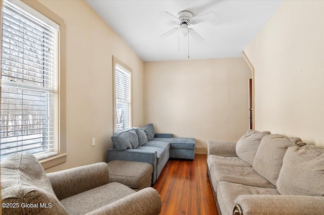 living area with dark wood-style floors and a ceiling fan