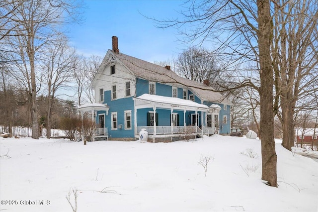 exterior space with covered porch and a chimney