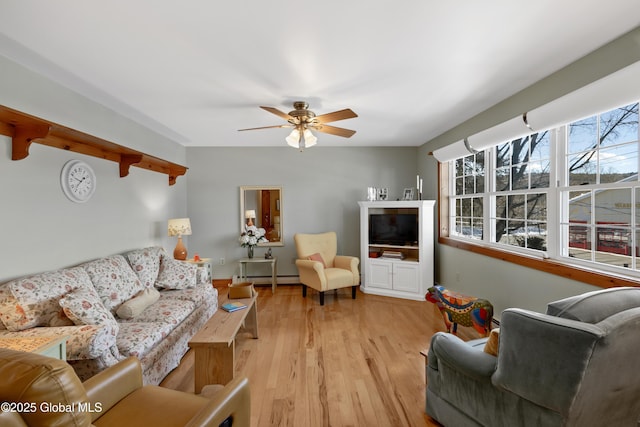 living room featuring light wood-style floors, a baseboard radiator, and a ceiling fan