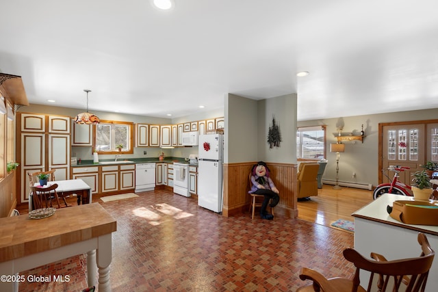 kitchen with white appliances, a baseboard heating unit, a sink, and recessed lighting