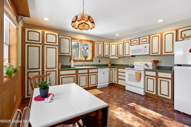 kitchen featuring brick floor, recessed lighting, white appliances, a sink, and decorative light fixtures