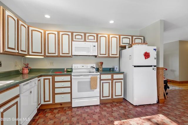 kitchen featuring dark countertops, white appliances, and recessed lighting