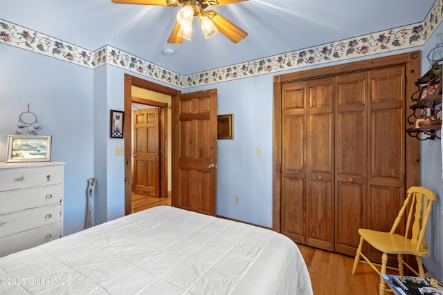 bedroom featuring light wood-type flooring, ceiling fan, and a closet