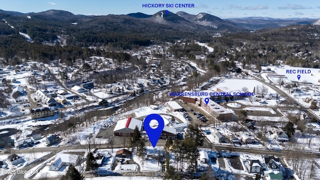 snowy aerial view featuring a mountain view