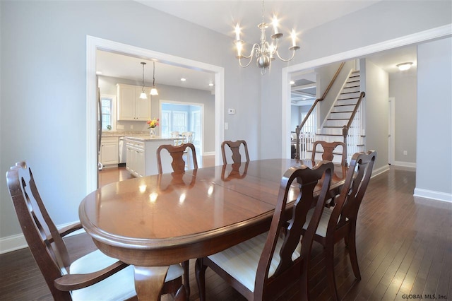 dining space featuring stairs, a notable chandelier, dark wood finished floors, and baseboards