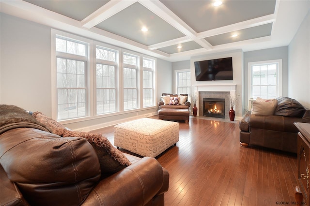 living area with recessed lighting, a fireplace with flush hearth, coffered ceiling, beamed ceiling, and hardwood / wood-style flooring