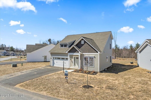 view of front of home with an attached garage and aphalt driveway