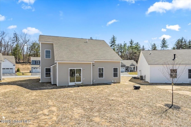 back of house featuring a shingled roof