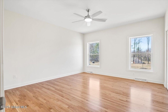 unfurnished room featuring visible vents and light wood-type flooring