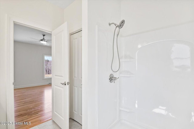 full bath featuring a shower, wood finished floors, and ceiling fan
