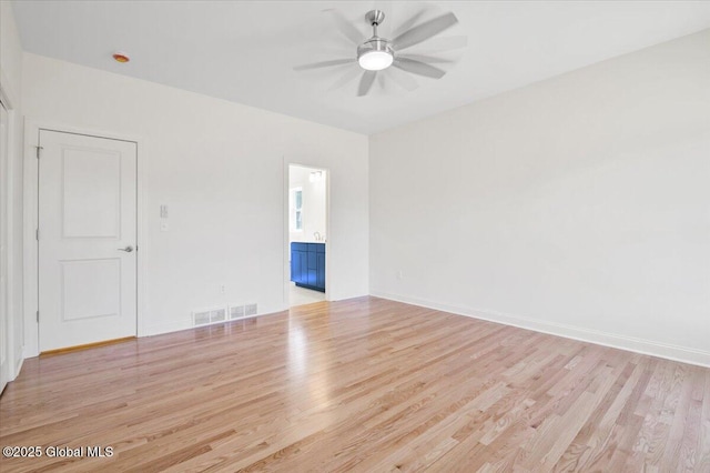 spare room with baseboards, visible vents, ceiling fan, and light wood-type flooring