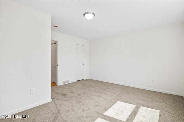 carpeted empty room with baseboards and visible vents