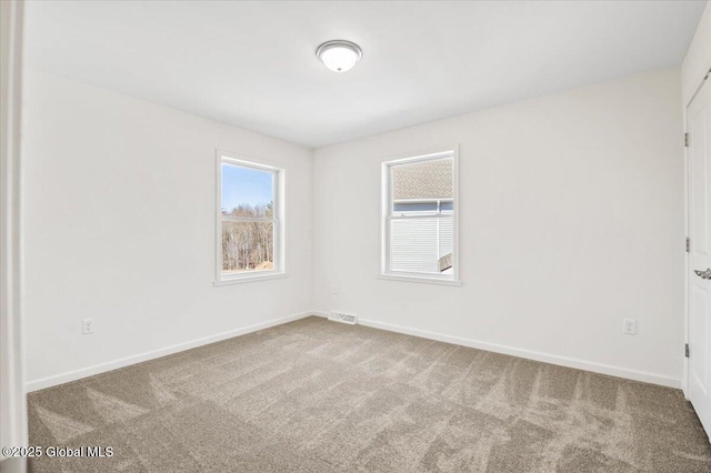 unfurnished room with carpet, baseboards, and visible vents