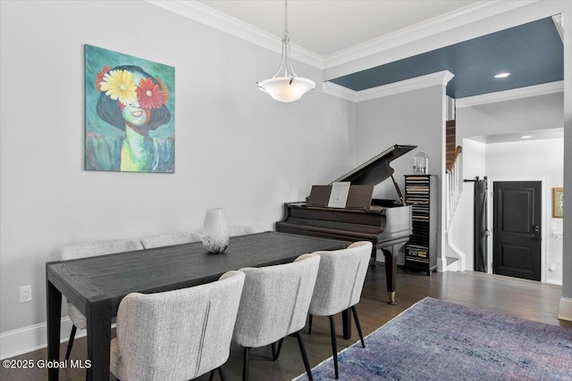 dining room featuring stairway, ornamental molding, baseboards, and wood finished floors