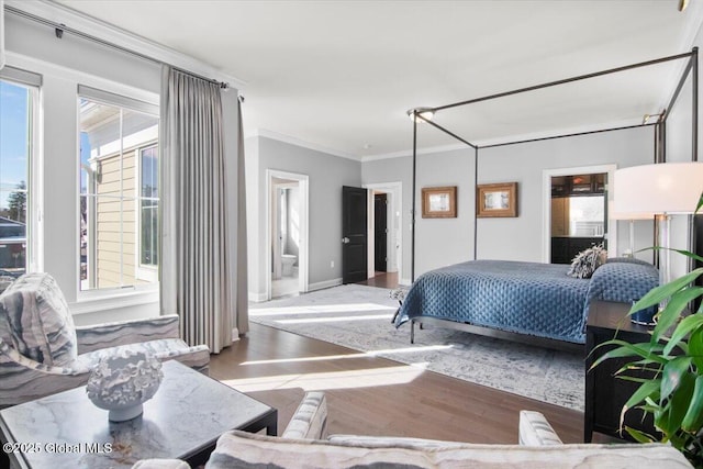 bedroom featuring wood finished floors and ornamental molding