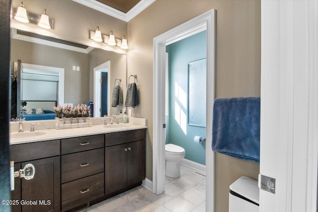 ensuite bathroom with marble finish floor, toilet, ornamental molding, and a sink