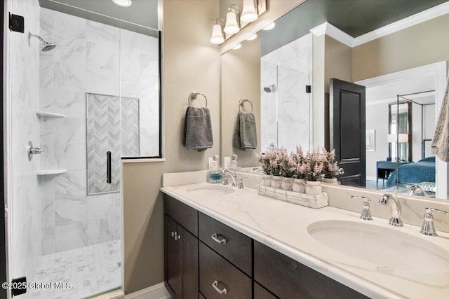 ensuite bathroom featuring a sink, a marble finish shower, double vanity, and crown molding