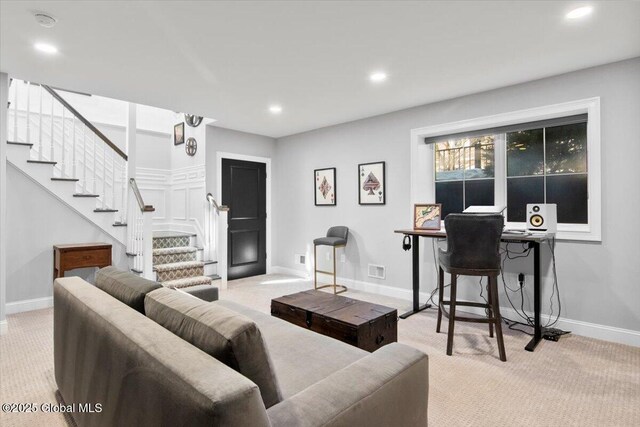 living room with recessed lighting, baseboards, light colored carpet, and stairs