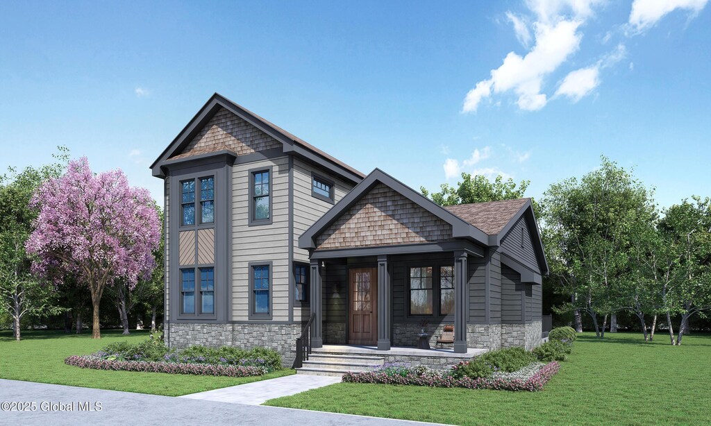 27 Oak Ridge Blvd, Saratoga Springs, NY 12866 - view of front of home with stone siding, a front lawn, and covered porch