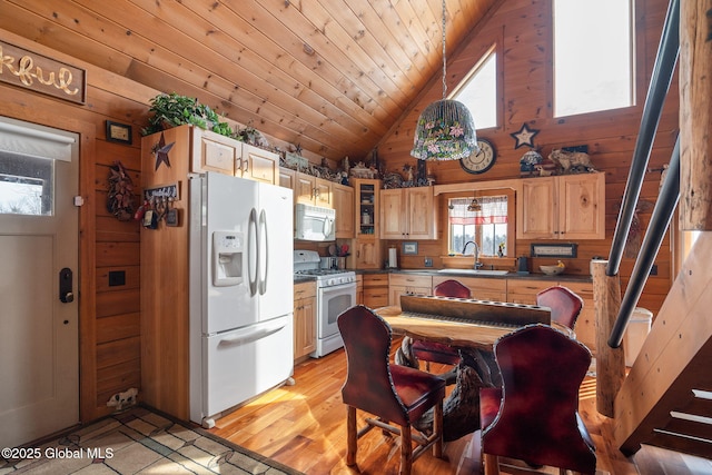 kitchen with white appliances, wooden ceiling, glass insert cabinets, wood walls, and a sink