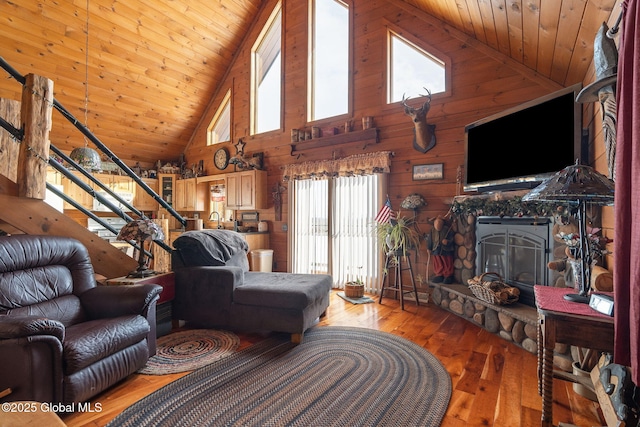 living room featuring wood walls, wood ceiling, vaulted ceiling, stairway, and hardwood / wood-style floors