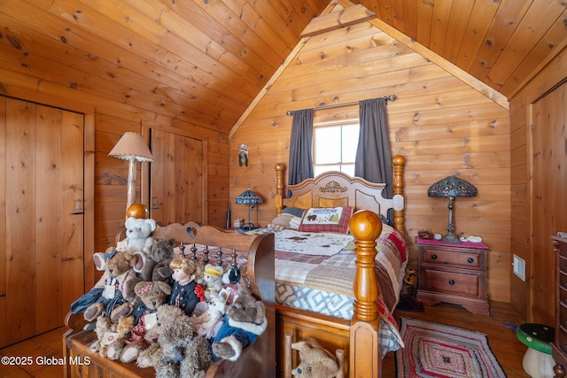 bedroom featuring lofted ceiling, wooden ceiling, wooden walls, and wood finished floors