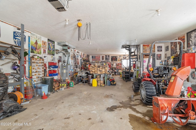 garage with a workshop area and a garage door opener