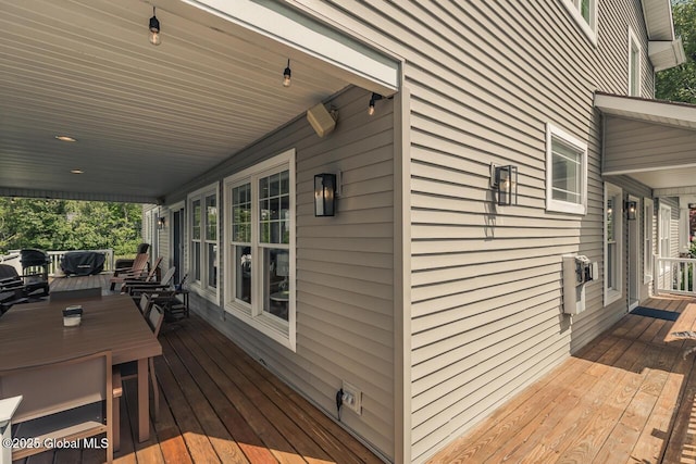 wooden terrace featuring covered porch