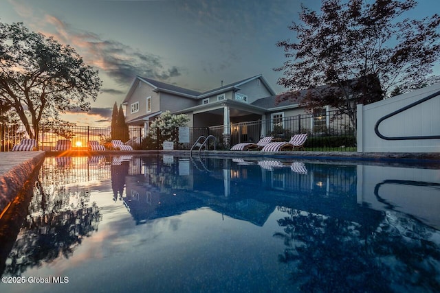 view of swimming pool featuring a patio area, fence, and a fenced in pool