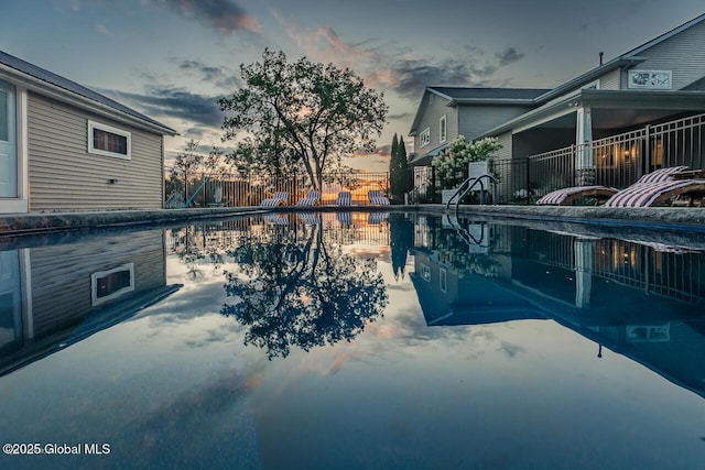 view of swimming pool featuring fence, a fenced in pool, and a patio