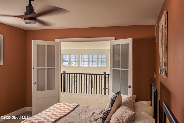 carpeted bedroom featuring ceiling fan and baseboards