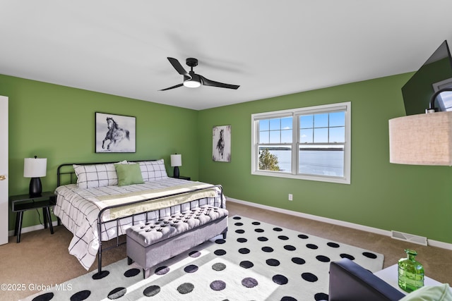 bedroom with ceiling fan, carpet flooring, visible vents, and baseboards