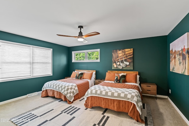 bedroom with baseboards, visible vents, ceiling fan, and carpet flooring