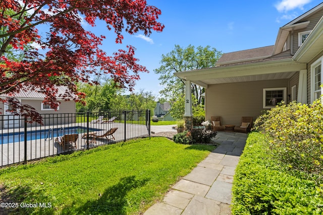 view of yard with fence and a fenced in pool