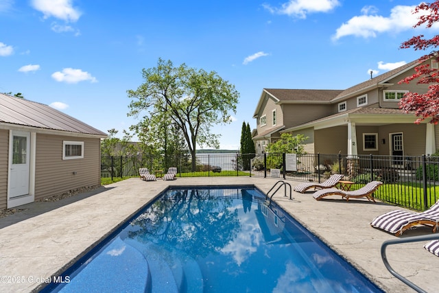 view of swimming pool with a patio area, fence, and a fenced in pool