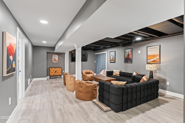 living room with light wood-type flooring and baseboards