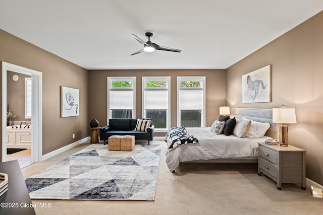 bedroom featuring baseboards, ceiling fan, connected bathroom, and light colored carpet