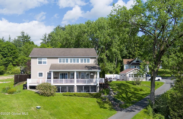 back of house with a lawn and a wooden deck