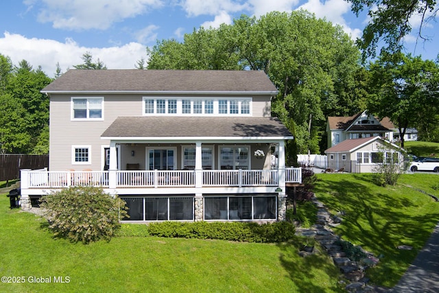 back of property with a yard and fence