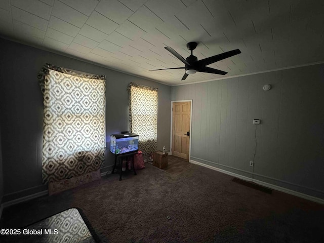 interior space featuring carpet floors, ceiling fan, visible vents, and baseboards