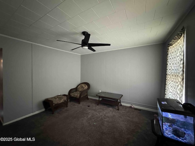 misc room with carpet floors, ceiling fan, baseboards, and crown molding