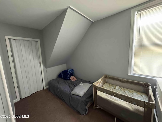 carpeted bedroom with lofted ceiling