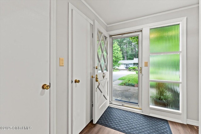 entryway featuring ornamental molding and wood finished floors