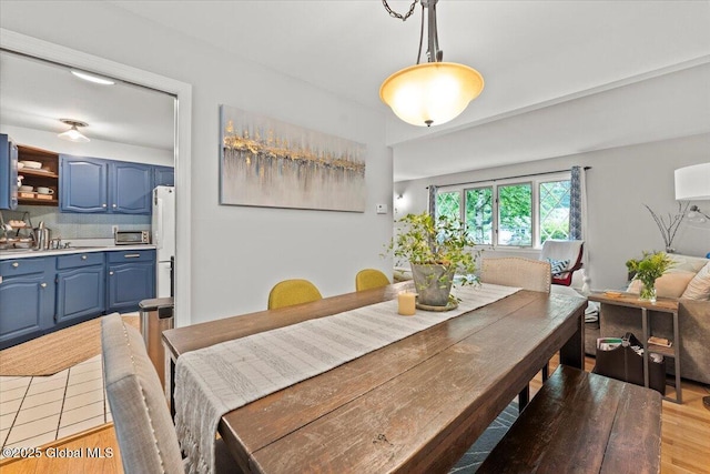 dining space featuring light wood-style flooring