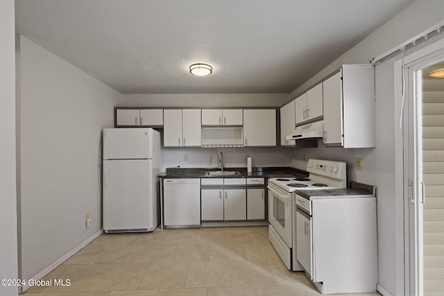 kitchen with dark countertops, white cabinets, a sink, white appliances, and under cabinet range hood