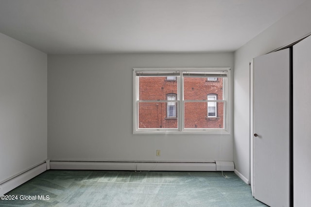 spare room with carpet and a baseboard radiator