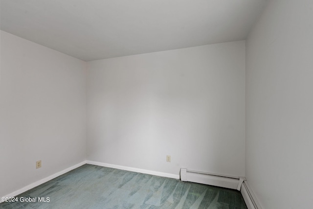 carpeted empty room featuring baseboards and baseboard heating