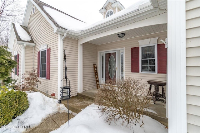 view of snow covered property entrance